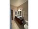 Bathroom features double sinks with brown cabinets, tile floors, granite countertops, and a linen closet at 17346 Nature Walk Trail Trl # 201, Parker, CO 80134