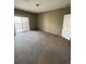 Spacious bedroom with sliding glass doors leading to the balcony and carpeted floors at 17346 Nature Walk Trail Trl # 201, Parker, CO 80134