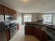 Modern kitchen with stainless steel appliances, granite counters, and a breakfast bar at 17346 Nature Walk Trail Trl # 201, Parker, CO 80134