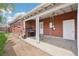 Covered patio with a white door leading to the backyard with a grill at 6086 W Arizona Ave, Lakewood, CO 80232
