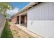 A partially fenced-in backyard with a covered patio, accessible through a white door at 6086 W Arizona Ave, Lakewood, CO 80232