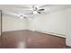 Unfurnished basement with wood floors, two ceiling fans, and window allows natural light to enter the space at 6086 W Arizona Ave, Lakewood, CO 80232