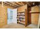 Open basement area featuring exposed wood and storage shelving at 6086 W Arizona Ave, Lakewood, CO 80232