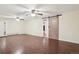 Large basement area featuring wood floors, barn door, drop ceiling with two ceiling fans and a closet at 6086 W Arizona Ave, Lakewood, CO 80232