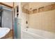 Bathroom featuring tiled shower, tiled walls, and a soaking tub at 6086 W Arizona Ave, Lakewood, CO 80232