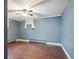 This bedroom has a ceiling fan, wood floors, and a window for natural light at 6086 W Arizona Ave, Lakewood, CO 80232