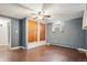 This bedroom has wood floors, a ceiling fan, and a closet with wooden doors at 6086 W Arizona Ave, Lakewood, CO 80232