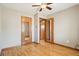Bedroom with hardwood floors, a closet, and a door leading to another room at 6086 W Arizona Ave, Lakewood, CO 80232