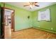 Bright bedroom with hardwood floors, a ceiling fan, and a door to another room at 6086 W Arizona Ave, Lakewood, CO 80232