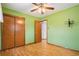 Bedroom featuring wood floors, a ceiling fan, and closet space at 6086 W Arizona Ave, Lakewood, CO 80232