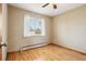 Bedroom with hardwood floors, a window, and a closet at 6086 W Arizona Ave, Lakewood, CO 80232