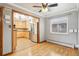 Light-filled dining room with wood floors, modern ceiling fan, and an archway leading to a stainless steel kitchen at 6086 W Arizona Ave, Lakewood, CO 80232