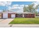 Charming red brick ranch-style home featuring an attached two-car garage and a well-maintained lawn at 6086 W Arizona Ave, Lakewood, CO 80232