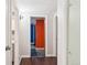 Basement hallway with brown floors leads to other rooms and features a peg board wall at 6086 W Arizona Ave, Lakewood, CO 80232