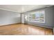 Bright living room features hardwood flooring and fresh neutral paint, creating a bright and inviting atmosphere at 6086 W Arizona Ave, Lakewood, CO 80232