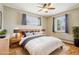 Comfortable primary bedroom with natural light, a plush bed, and modern furnishings at 6086 W Arizona Ave, Lakewood, CO 80232