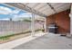 Back patio with a grill and a chiminea next to a brick wall under a covered roof at 6086 W Arizona Ave, Lakewood, CO 80232
