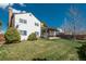 Spacious backyard with lush lawn, mature trees, and a charming covered patio for outdoor entertaining at 15930 E Ford Pl, Aurora, CO 80017