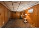 Spacious basement rec room featuring carpet, wood paneled walls, and ample lighting at 15930 E Ford Pl, Aurora, CO 80017