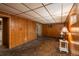 Basement rec room featuring carpet, wood paneled walls, and ample lighting at 15930 E Ford Pl, Aurora, CO 80017