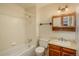 Cozy bathroom features a bath and shower combo, vanity, and decorative mirror at 15930 E Ford Pl, Aurora, CO 80017