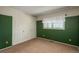 Bedroom featuring dark green walls, carpet and a double door closet at 15930 E Ford Pl, Aurora, CO 80017