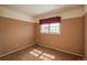 Bedroom featuring neutral carpet, a window, and colored walls, creating a simple yet comfortable space at 15930 E Ford Pl, Aurora, CO 80017
