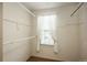 Walk-in closet featuring hanging rods and a window with sheer curtains providing natural light and ventilation at 15930 E Ford Pl, Aurora, CO 80017