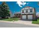 Charming two-story home with brick facade, manicured lawn, and attached two-car garage at 15930 E Ford Pl, Aurora, CO 80017