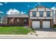 Charming two-story home with brick facade, manicured lawn, and attached two-car garage at 15930 E Ford Pl, Aurora, CO 80017