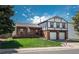 Charming two-story home with a well-manicured lawn, brick facade, and attached two-car garage at 15930 E Ford Pl, Aurora, CO 80017