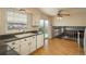 Bright kitchen with wood floors, a window, and sliding glass doors to the backyard at 15930 E Ford Pl, Aurora, CO 80017