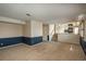 Spacious living area with carpet, two-tone paint, steps to the kitchen, and shuttered windows for natural light at 15930 E Ford Pl, Aurora, CO 80017