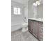 Updated bathroom with gray tile floor, new vanity, and bathtub at 6087 W 61St Pl, Arvada, CO 80003