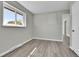 Bright bedroom with neutral walls, vinyl flooring, and window at 6087 W 61St Pl, Arvada, CO 80003