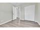 Bedroom with grey vinyl flooring and double door closet at 6087 W 61St Pl, Arvada, CO 80003