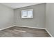 Simple bedroom with vinyl flooring, neutral walls, and a window at 6087 W 61St Pl, Arvada, CO 80003