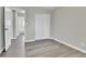 Bedroom with grey vinyl flooring, closet, and access to bathroom at 6087 W 61St Pl, Arvada, CO 80003