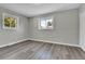 Well-lit bedroom featuring neutral walls and vinyl flooring at 6087 W 61St Pl, Arvada, CO 80003