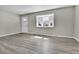 Living room features bay window, vinyl flooring, and neutral walls at 6087 W 61St Pl, Arvada, CO 80003