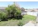 Spacious backyard with green grass, privacy fence, and large shade tree at 20194 Robins Dr, Denver, CO 80249