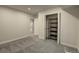 Basement bedroom featuring closet with shelves and neutral walls and carpet at 20194 Robins Dr, Denver, CO 80249