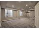 Spacious finished basement with neutral paint, carpet, recessed lights, and large windows at 20194 Robins Dr, Denver, CO 80249