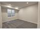 Basement bedroom with carpet, large window, and neutral paint at 20194 Robins Dr, Denver, CO 80249