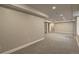 Spacious finished basement with neutral walls and gray carpet at 20194 Robins Dr, Denver, CO 80249