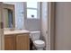 Well-lit bathroom with single sink vanity and a separate toilet area at 20194 Robins Dr, Denver, CO 80249
