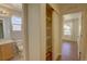 Neutral bathroom showcasing a toilet, vanity and closet for extra storage at 20194 Robins Dr, Denver, CO 80249