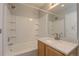 Clean, neutral bathroom with white tiled tub and shower, and a white vanity at 20194 Robins Dr, Denver, CO 80249