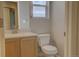 Cozy bathroom featuring a white vanity, toilet, window and neutral wall color at 20194 Robins Dr, Denver, CO 80249