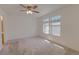 Neutral bedroom with ceiling fan, carpeted floors and ample natural light at 20194 Robins Dr, Denver, CO 80249